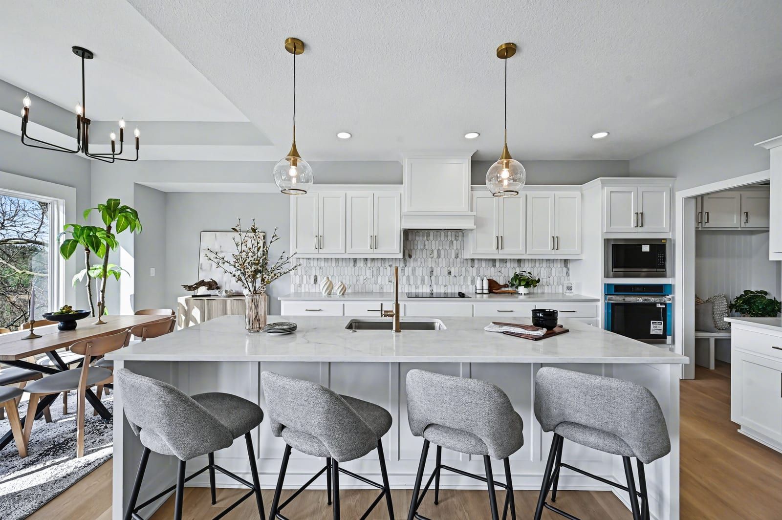 Kitchen with quartz island and brass fixtures